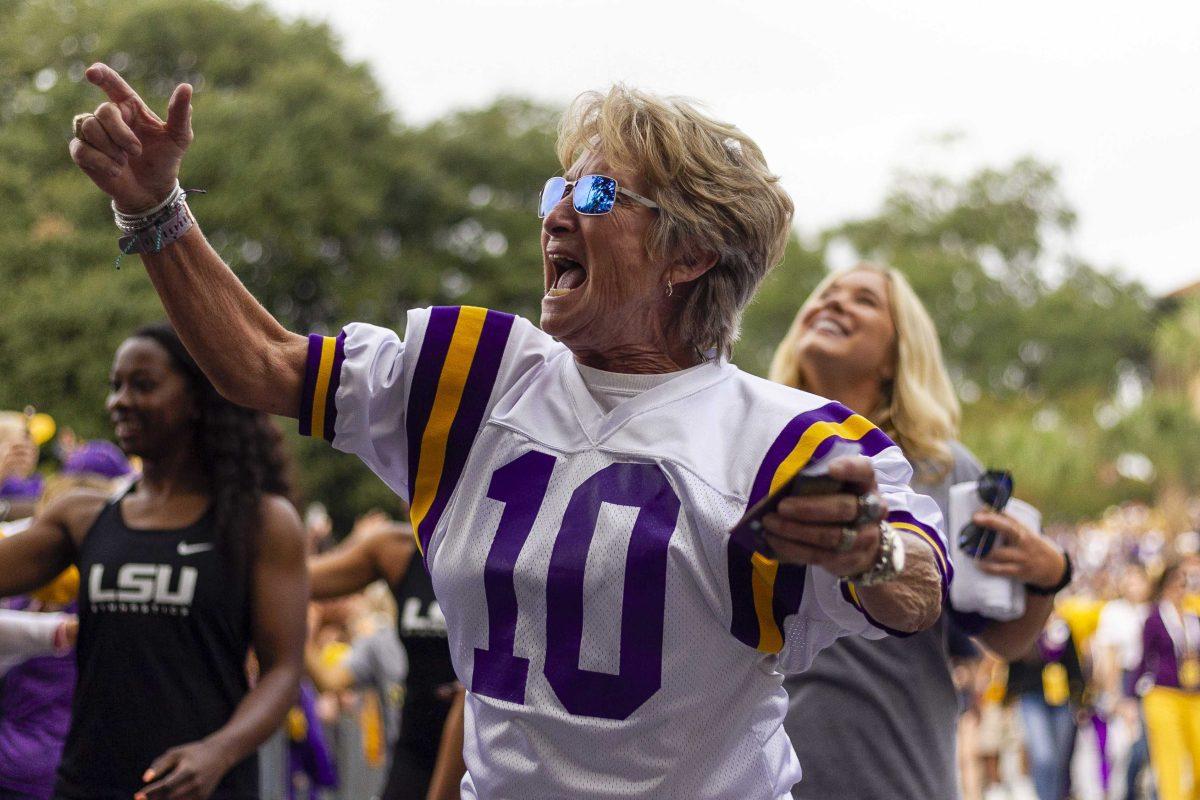 LSU gymnastics coach D-D Breaux walks down victory hill on Saturday, Oct. 12, 2019.