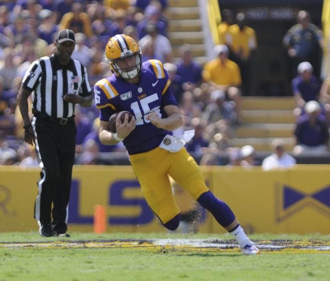 LSU sophomore quarterback Myles Brennan (15) carries the ball against Utah State at Tiger Stadium on Saturday, Oct. 5, 2019.