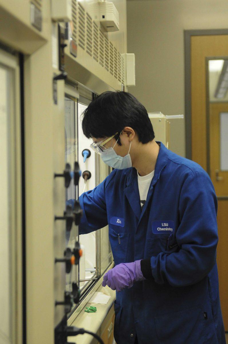 Chemistry graduate student Xin Zhou conducts lab work Monday, Aug. 31, 2020 for Professor Semin Lee's NSF research grant in the Chemistry and Materials Building on Highland rd.