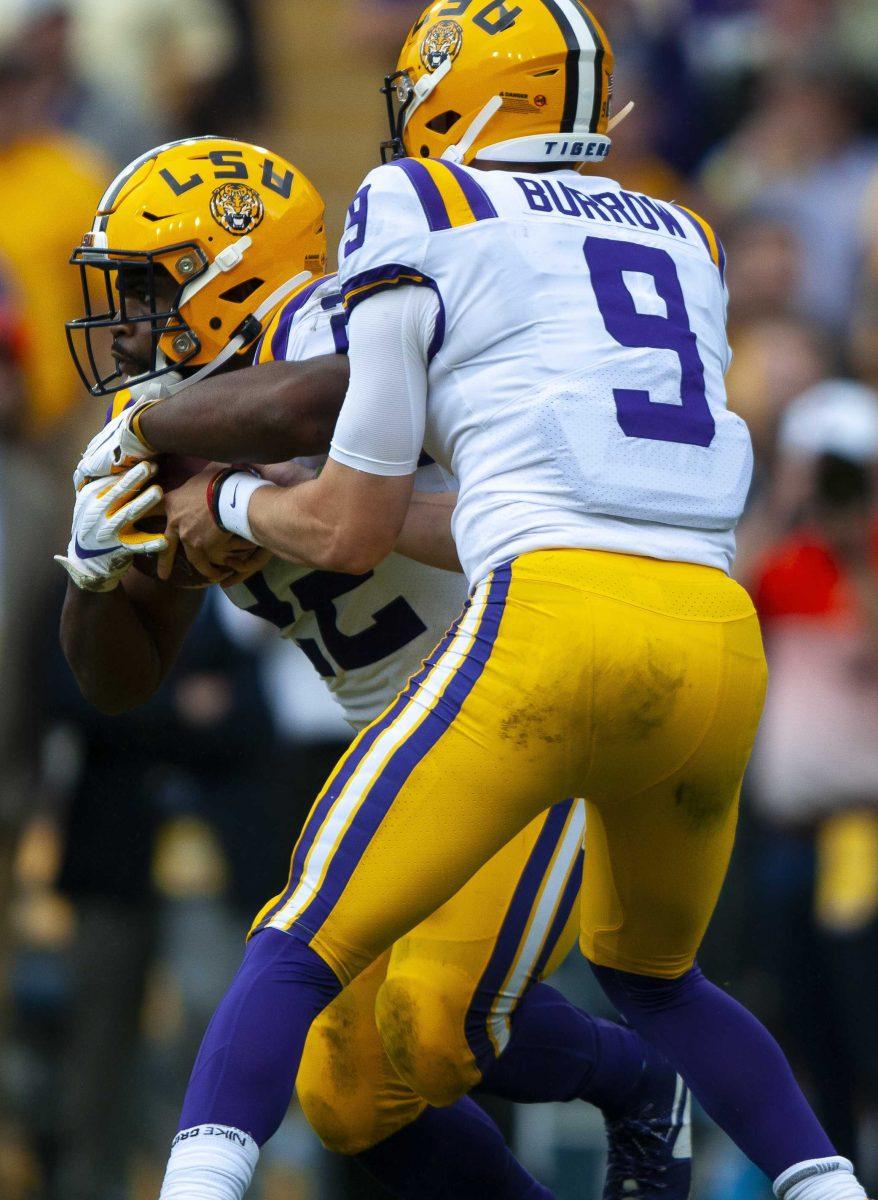 LSU senior quarterback Joe Burrow (9) hands the ball off to LSU junior running back Clyde Edwards-Helaire (22) during the Tigers&#8217; 23-20 victory over Auburn on Saturday, Oct. 26, 2019, in Tiger Stadium.