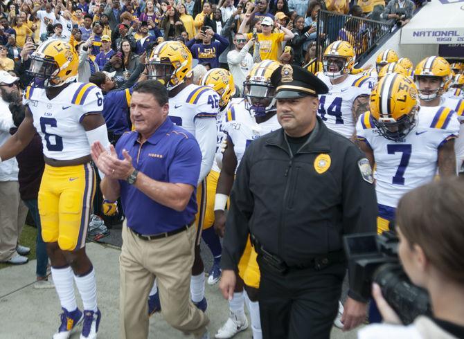 LSU football coach Ed Orgeron and his players walk on the field before the Tigers' game against Auburn on Saturday, Oct. 26, 2019, at Tiger Stadium.