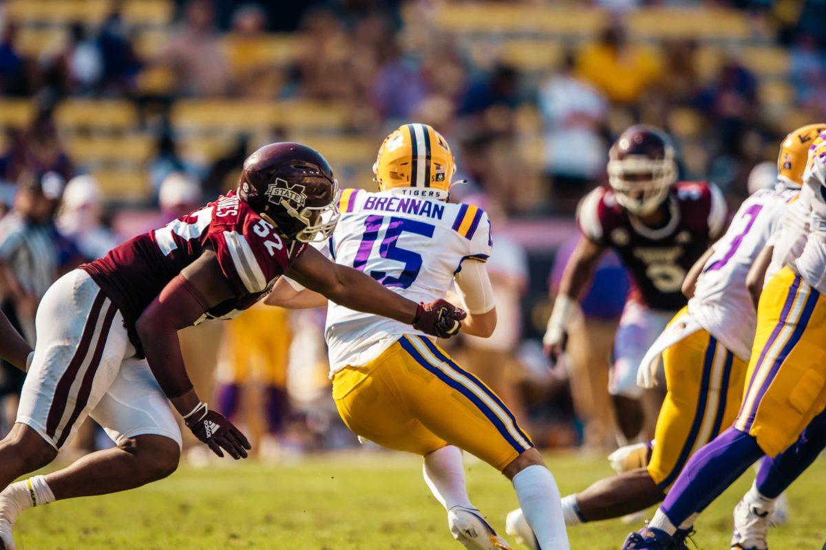 LSU football junior quarterback Myles Brennan (15) escapes a tackle Saturday, Sep. 26, 2020 during LSU's 44-24 loss against Mississippi State in Tiger Stadium.