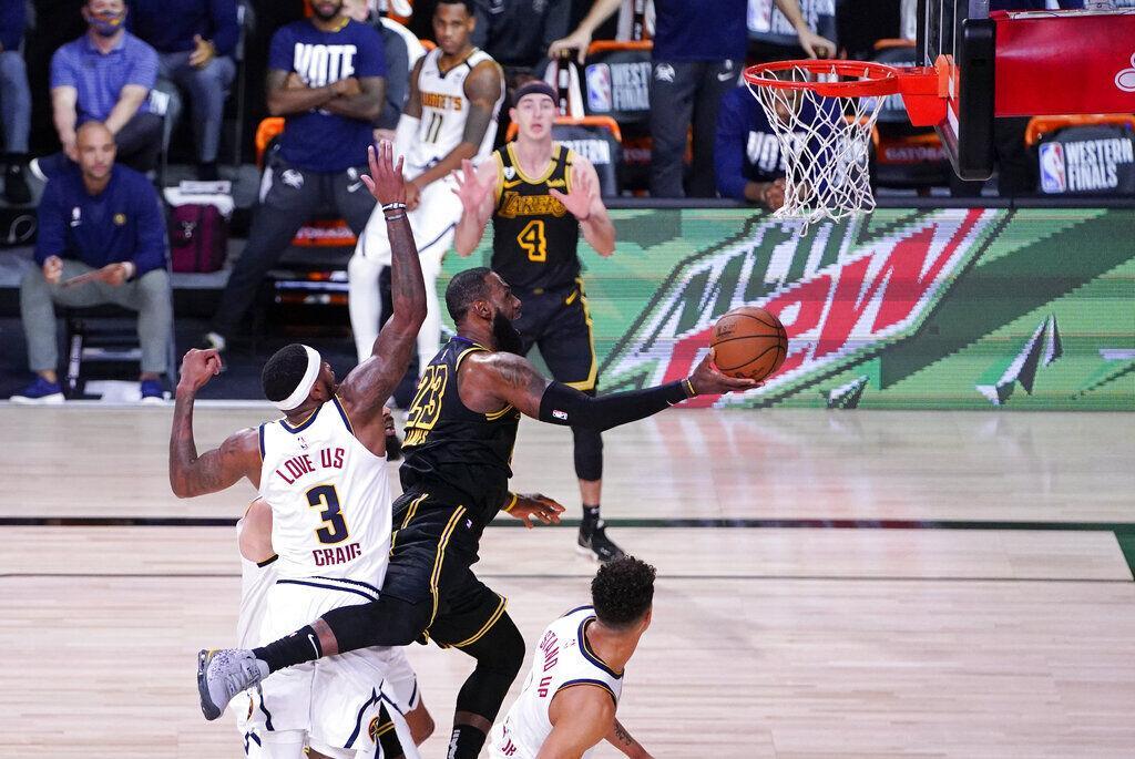 Los Angeles Lakers' LeBron James (23) drives to the basket past Denver Nuggets' Torrey Craig (3) during the second half of an NBA conference final playoff basketball game Sunday, Sept. 20, 2020, in Lake Buena Vista, Fla. The Lakers won 105-103.&#160;