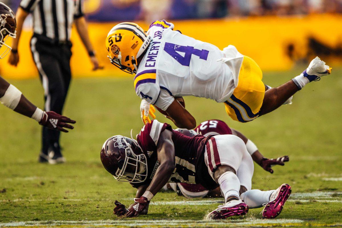 LSU football sophomore running back John Emery Jr. (4) gets brought to the ground by Mississippi State players Saturday, Sep. 26, 2020 during LSU's 44-24 loss against Mississippi State in Tiger Stadium.