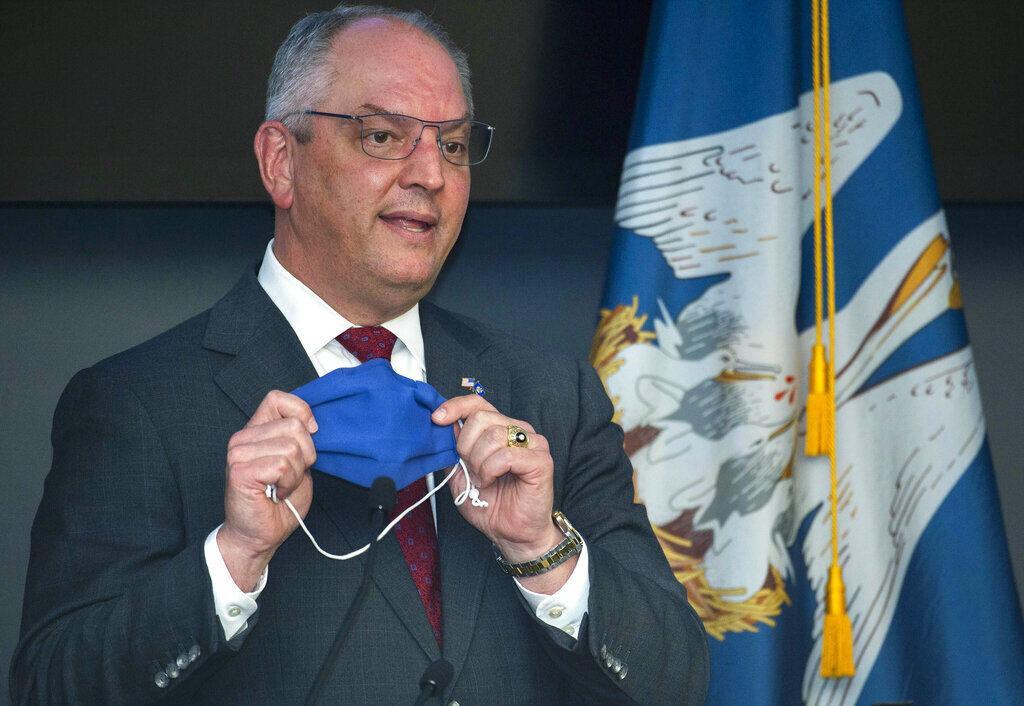 Louisiana Gov. John Bel Edwards holds up his own mask, taken off while he was speaking, to remind Louisiana residents that a highly effective thing within their power to do to prevent the spread of COVID-19 is to simply wear a mask, Tuesday, July 28, 2020, at a press conference update on the state's COVID-19 situation at the Governor's Office of Homeland Security and Emergency Preparedness in Baton Rouge, La.&#160;