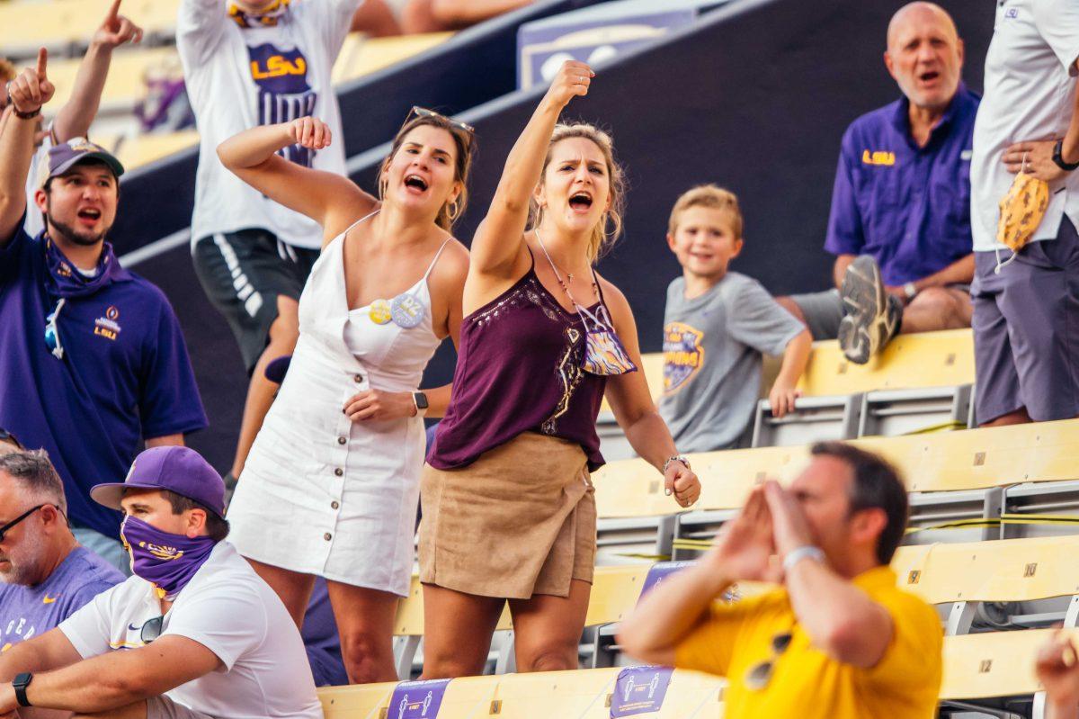 Two LSU fans cheer Saturday, Sep. 26, 2020 during LSU's 44-24 loss against Mississippi State in Tiger Stadium.