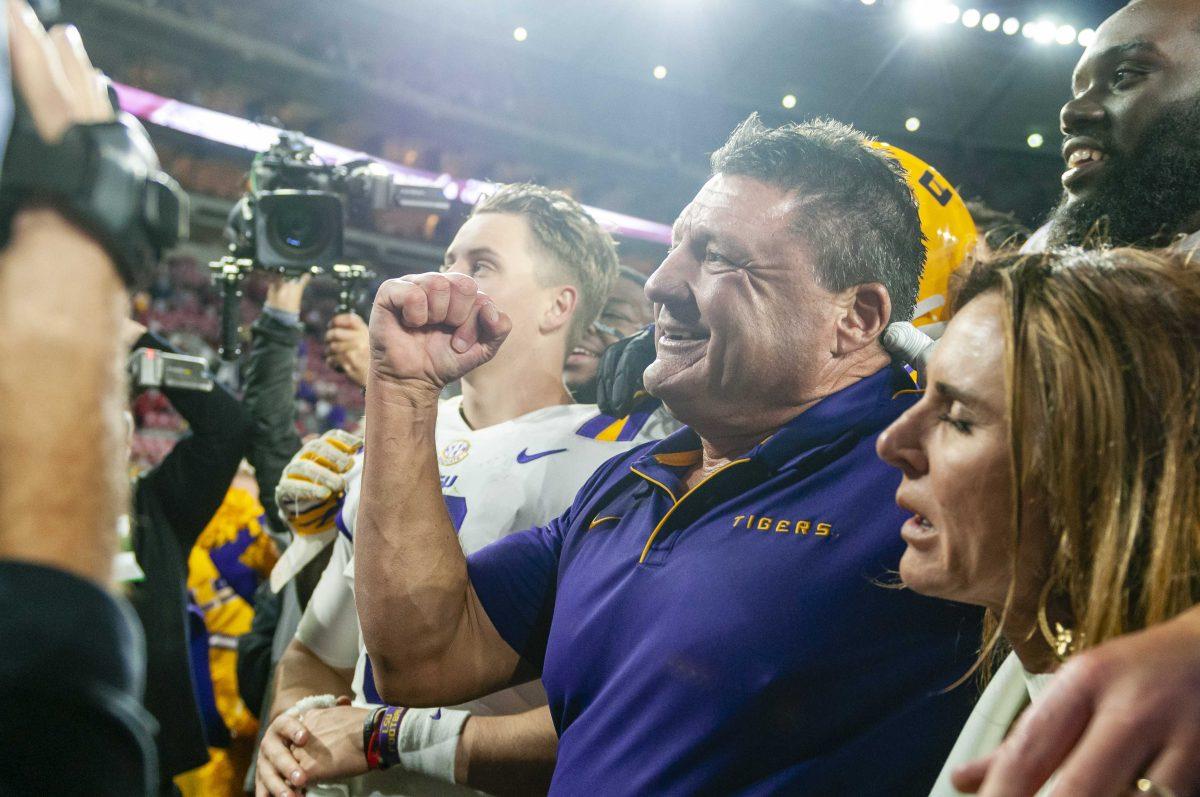 LSU senior quarterback Joe Burrow (9) and football coach Ed Orgeron celebrate after the Tigers' 46-41 victory over Alabama in Bryant-Denny Stadium on Saturday, Nov. 9, 2019.