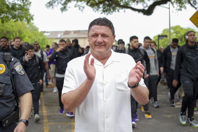 LSU football coach Ed Orgeron marches down Victory Hill on Saturday, April 6, 2019.