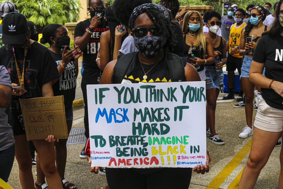 Kinesiology freshman Faith Jackson displays sign during "March On LSU" demonstration on Saturday, Sept. 5, 2020 at the Parade Ground on LSU's campus.&#160;