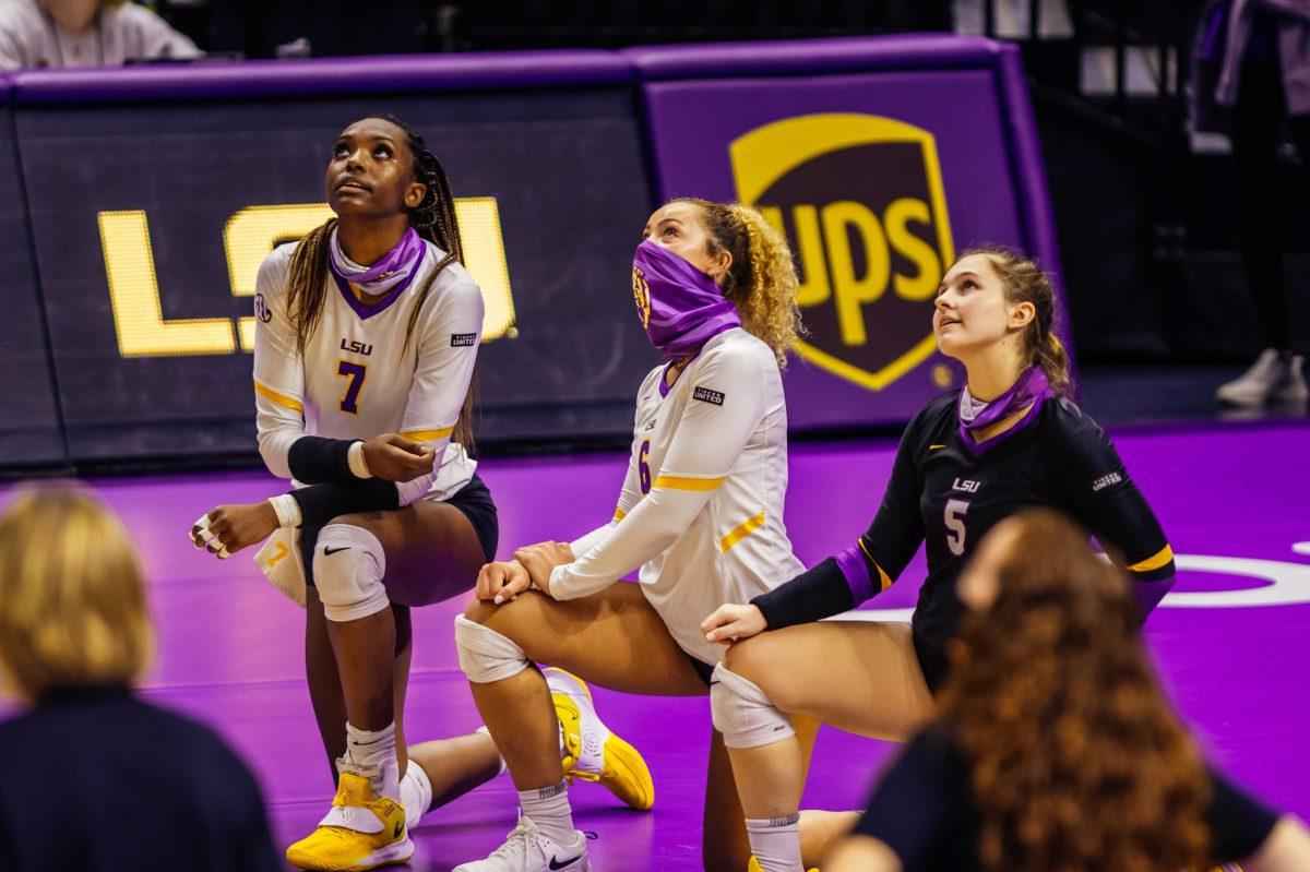 LSU volleyball players senior right side hitter Taylor Bannister (7), redshirt sophomore setter Darian Goins (6), and senior libero Raigen Cianciulli (5) kneel on Wednesday, Oct. 21, 2020 during a video against racial injustice before LSU volleyball's 3-1 win against Mississippi State at the Pete Maravich Assembly Center on N Stadium Drive.