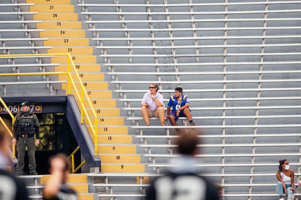 Two LSU fans wait for the game to begin Saturday, Sep. 26, 2020 before LSU's 44-24 loss against Mississippi State in Tiger Stadium.