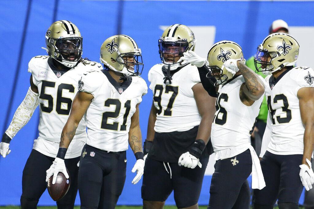 New Orleans Saints cornerback Patrick Robinson (21) celebrates with teammates after intercepting a pass in the end zone during the first half of an NFL football game against the Detroit Lions, Sunday, Oct. 4, 2020, in Detroit.