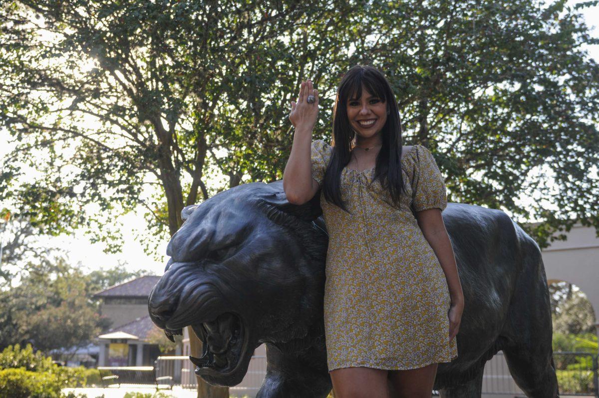 Mass communication major junior Schuyler Olson poses with her Tiger band championship ring Oct. 5, 2020 in front of Mike the Tiger's Habitat.