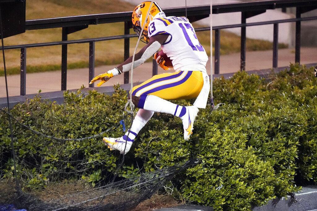 LSU wide receiver Jontre Kirklin jumps into a hedge after scoring a touchdown against Vanderbilt in the second half of an NCAA college football game Saturday, Oct. 3, 2020, in Nashville, Tenn. LSU won 41-7.&#160;