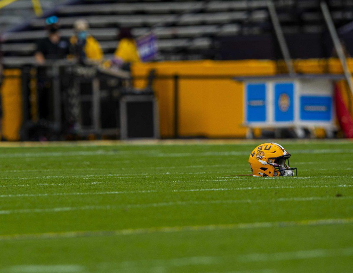 An LSU helmets sits on the field before the game Saturday, Oct. 24, 2020 before LSU's 52-24 win against South Carolina in Tiger Stadium.