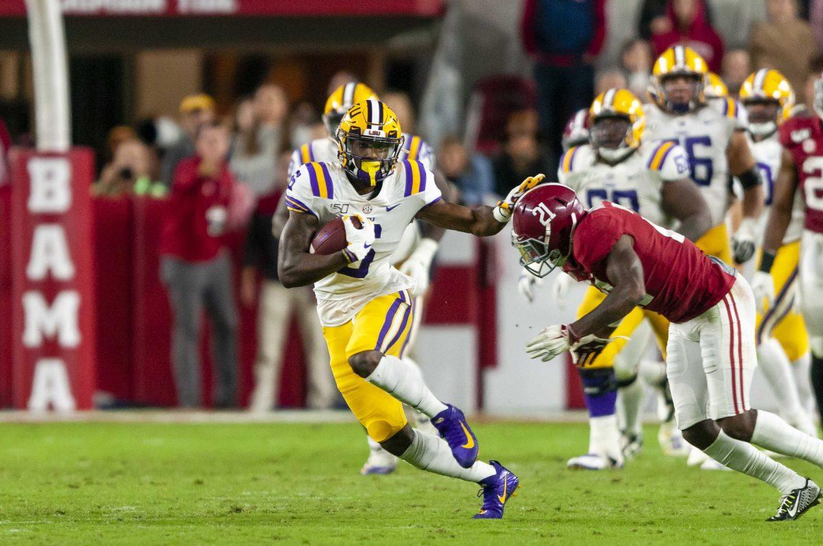 LSU sophomore wide receiver Terrace Marshall (6) stiff arms a defender during the Tigers' 46-41 victory over Alabama in Bryant-Denny Stadium on Saturday, Nov. 9, 2019.