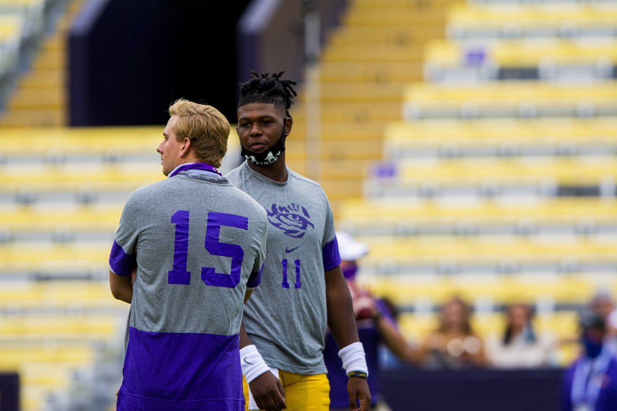 LSU football quarterbacks freshman TJ Finley (11) and junior Myles Brennan (15) talk during warmups Saturday, Oct. 24, 2020 before LSU's 52-24 win against South Carolina in Tiger Stadium.