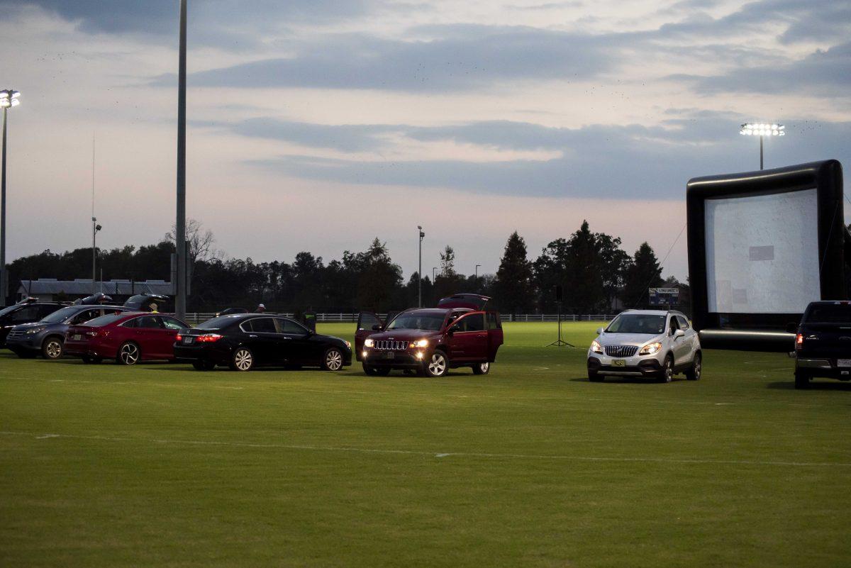 Cars park in front of the drive-in movie screen on Thursday, Oct. 15, 2020 at the UREC Field Complex off of Gourrier Rd.