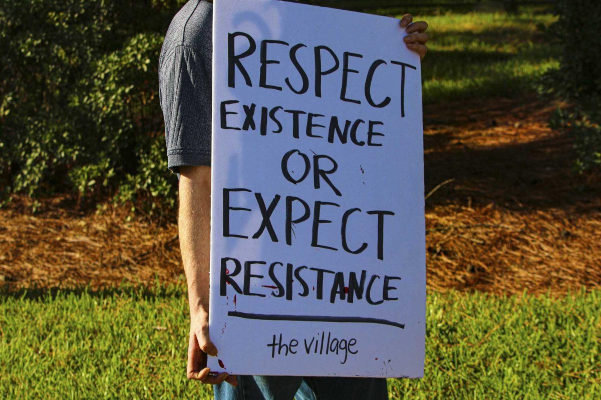 A protester holds up sign on Friday, Sept. 25, 2020 during protest in front of the Louisiana Governor's Mansion.