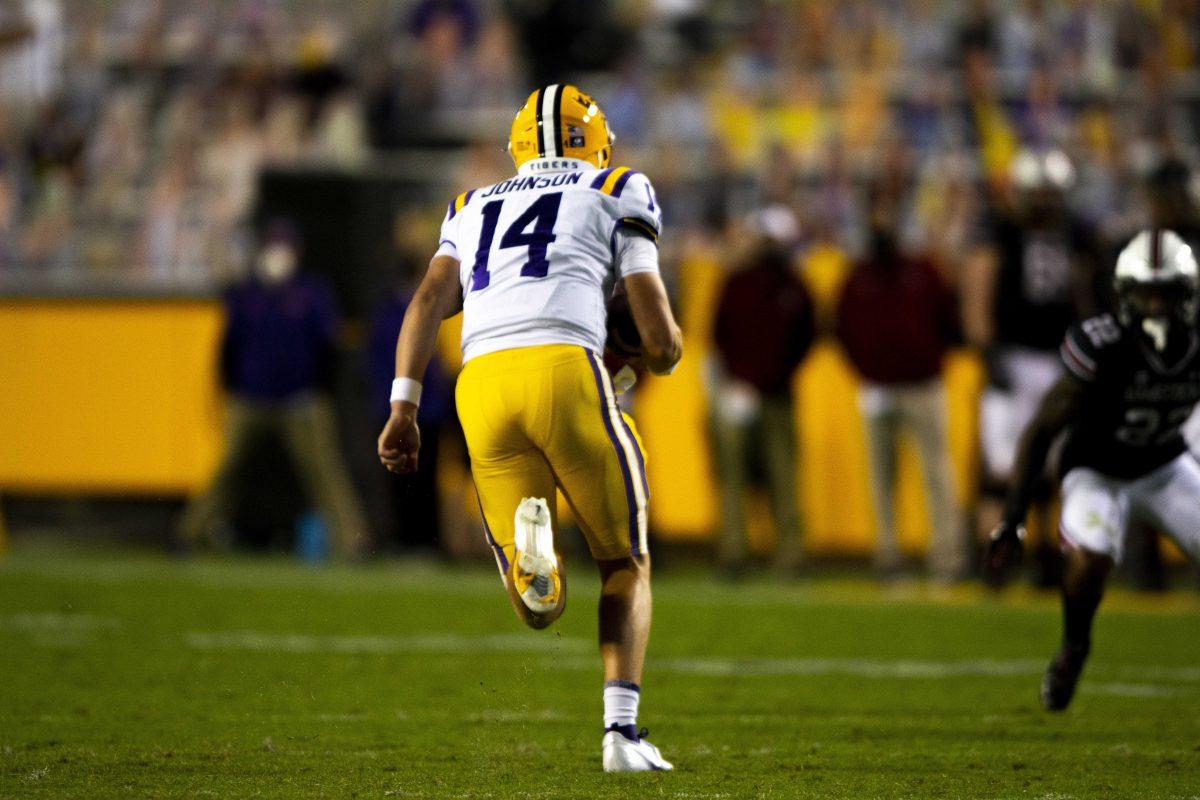 LSU football freshman quarterback Max Johnson (14) runs the ball Saturday, Oct. 24, 2020 during LSU's 52-24 win against South Carolina in Tiger Stadium.