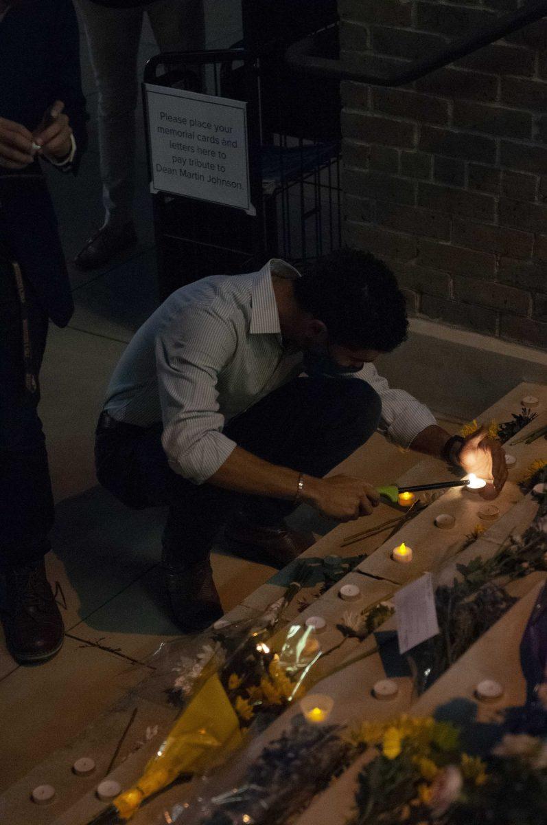 Students, staff and friends attend a vigil for Dean Martin Johnson Thursday, Oct. 1, 2020 and light candles to remember him outside of the Journalism Building.