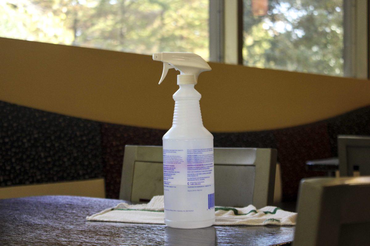 A bottle of disinfectant sits Friday Nov. 13, 2020 to clean each table after use at The 5 dining hall.