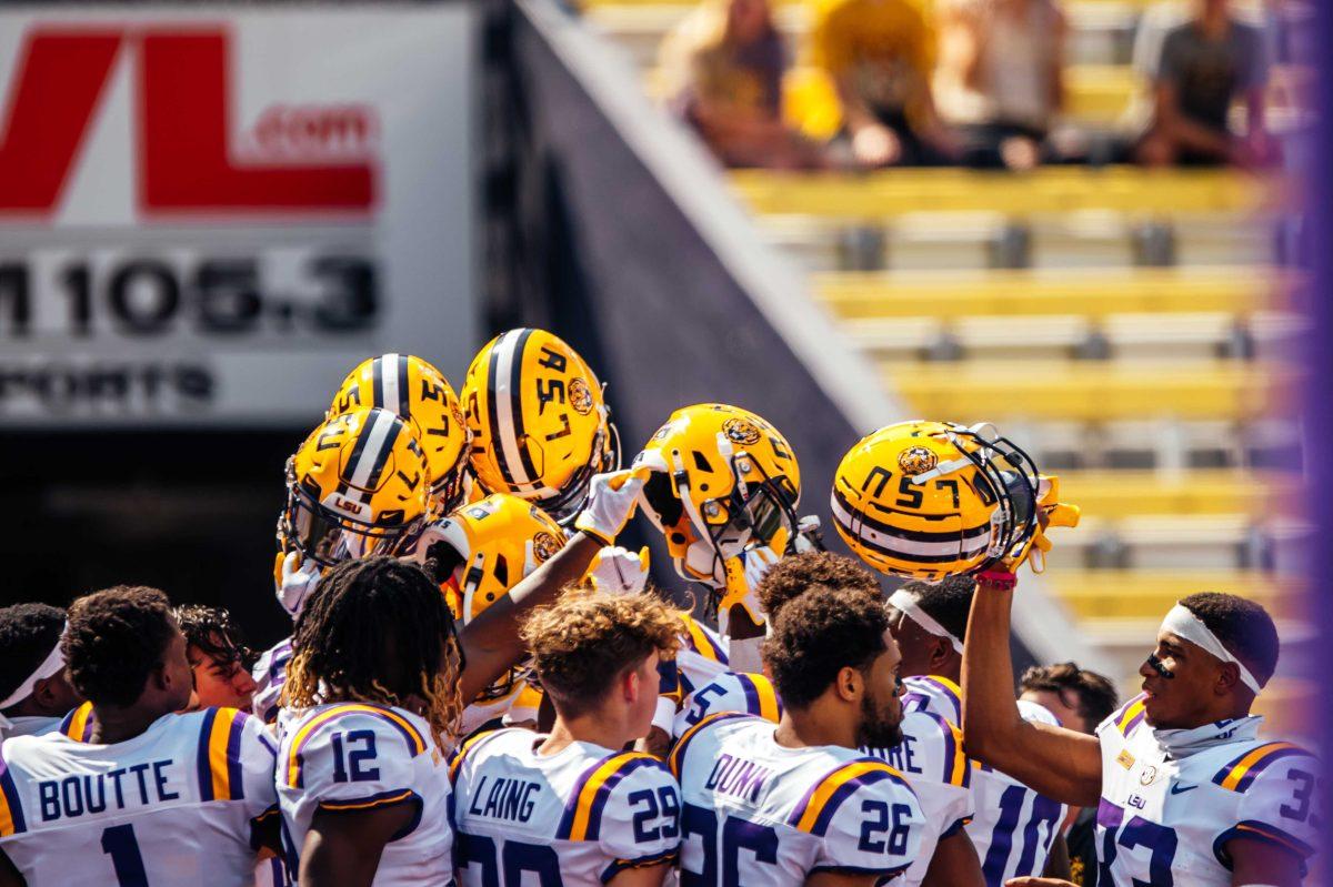 LSU football players raise their helmets Saturday, Sep. 26, 2020 before LSU's 44-24 loss against Mississippi State in Tiger Stadium.