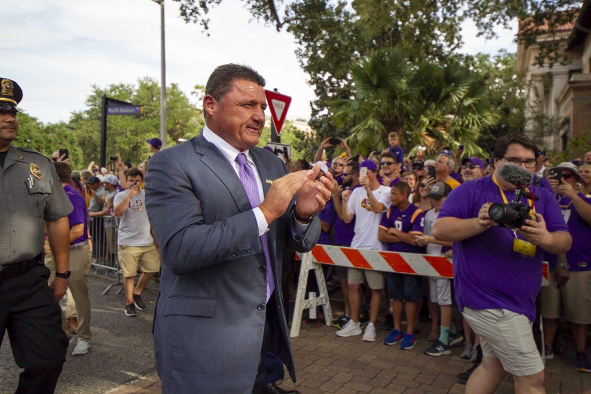 LSU football coach Ed Orgeron walks down Victory Hill on Saturday, Sept. 14, 2019.