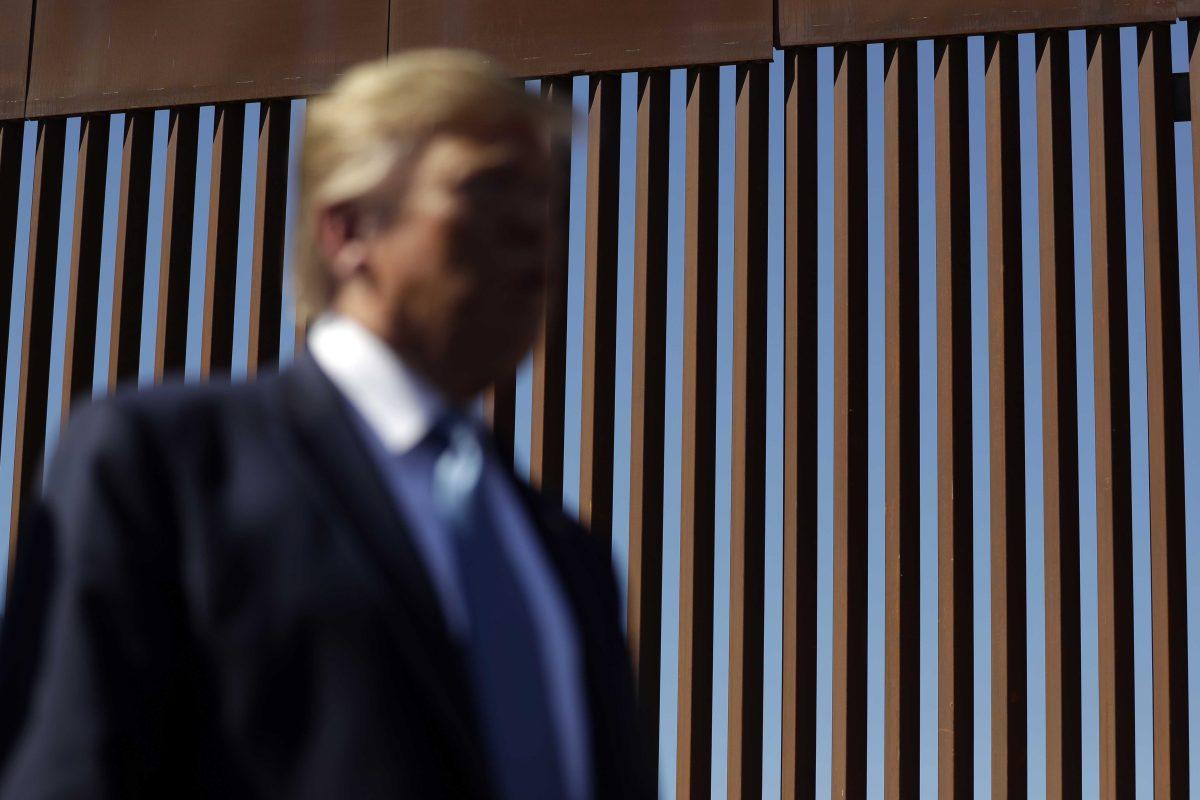 President Donald Trump talks with reporters as he tours a section of the southern border wall, Wednesday, Sept. 18, 2019, in Otay Mesa, Calif. (AP Photo/Evan Vucci)