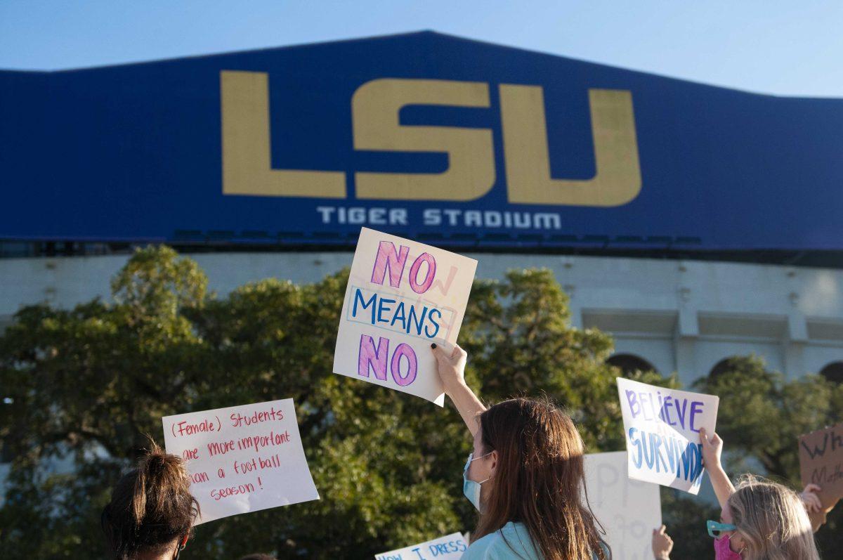 Protestors hold up signs Friday, Nov. 20, 2020 during the protest following the USA Today article about mishandled sexual misconduct cases at Tiger Stadium on North Stadium road.