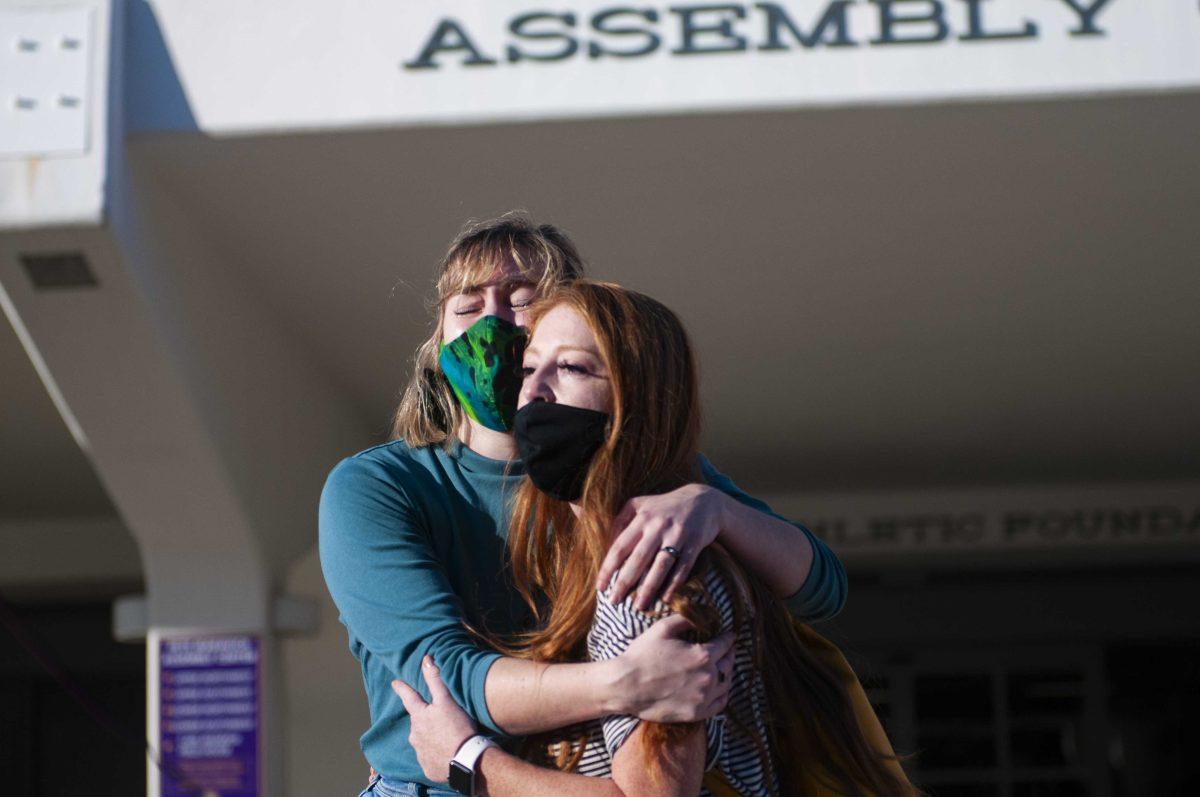 Elisabeth Andries and Samantha Brennan, both mentioned in the USA Today article, embrace each other Friday, Nov. 20, 2020 during the protest following the USA Today article about mishandled sexual misconduct cases at Tiger Stadium on North Stadium road.