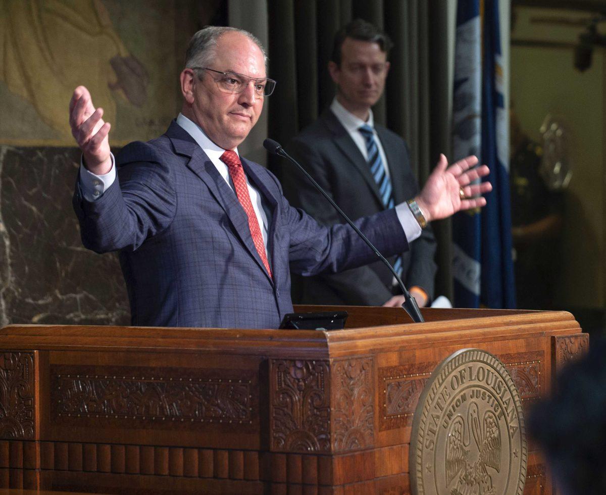 Gov. John Bel Edwards speaks Monday, May 11, 2020, at his media briefing on the state's COVID-19 response at the State Capitol in Baton Rouge, La., announcing that his stay-at-home directive will end with the Phase 1 reopening of the state on Friday, May 15. Dr. Alex Billioux, M.D., right, assistant secretary of health for the La. Dept. of Health's Office of Public Health, looks on. (Travis Spradling/The Advocate via AP, Pool)