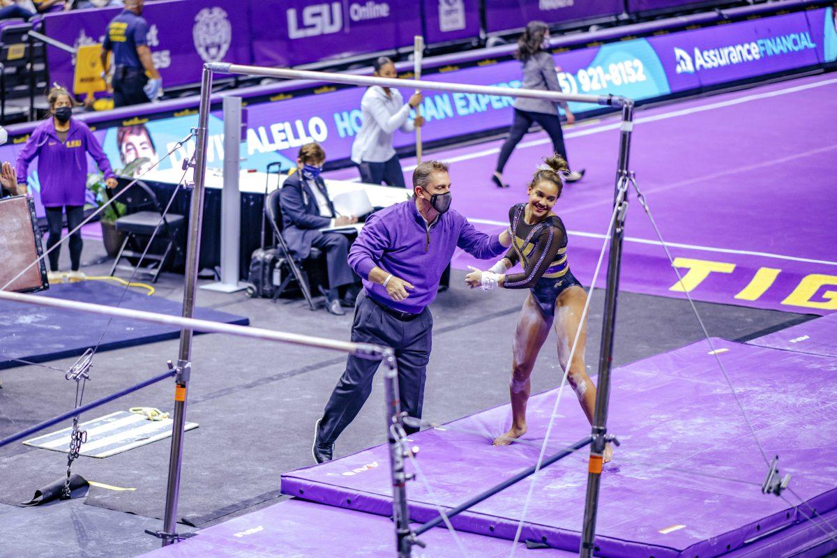 LSU gymnastics head coach Jay Clark congratulates freshman all-around Haleigh Bryant Friday, Jan. 8, 2021 after her uneven bars routine during No. 3 LSU gymnastics' 196.550-196.350 win against No. 15 Arkansas in the Pete Maravich Assembly Center on N Stadium Drive in Baton Rouge, La.