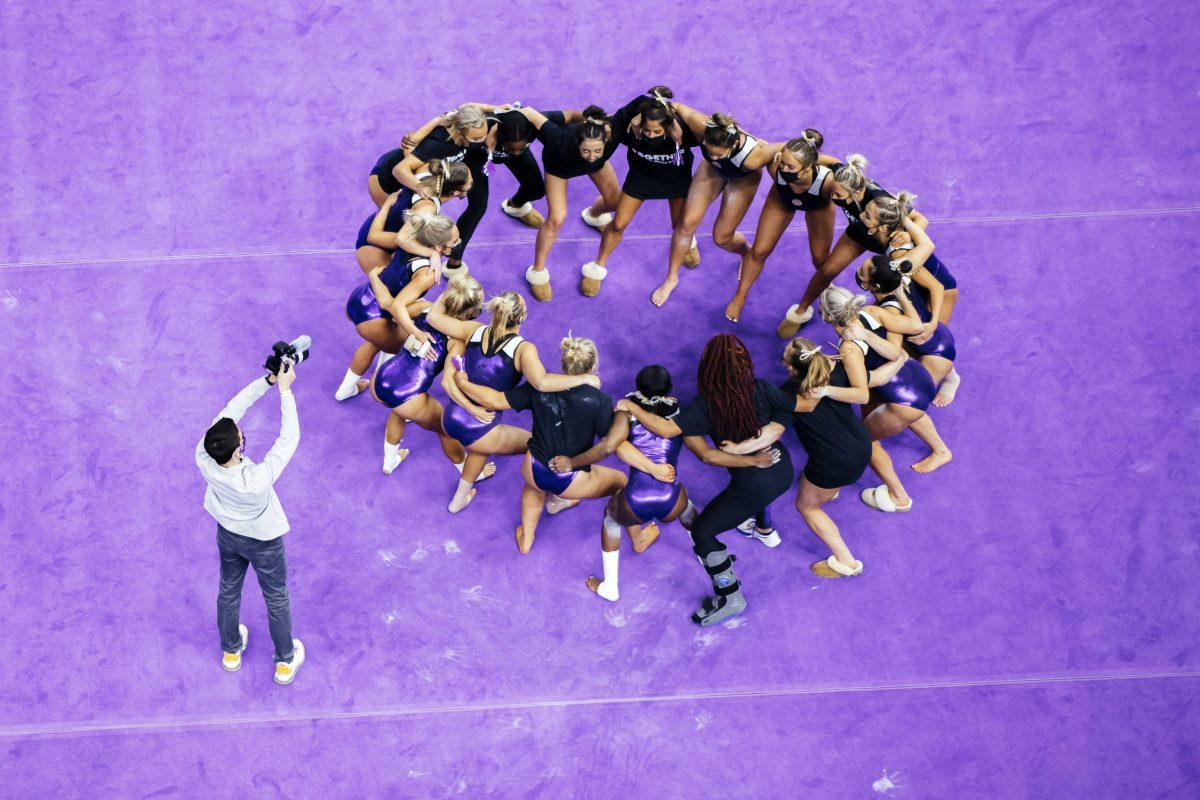 The LSU gymnastics team gathers in a circle Friday, Jan. 8, 2021 before No. 3 LSU gymnastics' 196.550-196.350 win against No. 15 Arkansas in the Pete Maravich Assembly Center on N Stadium Drive in Baton Rouge, La.