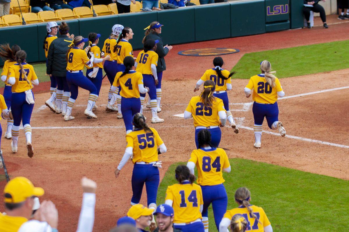 LSU softball players run to celebrate second homerun on Sunday, Feb. 16, 2020 during the Tiger's 4-3 win against University of Louisiana Lafayette in Tiger Park.