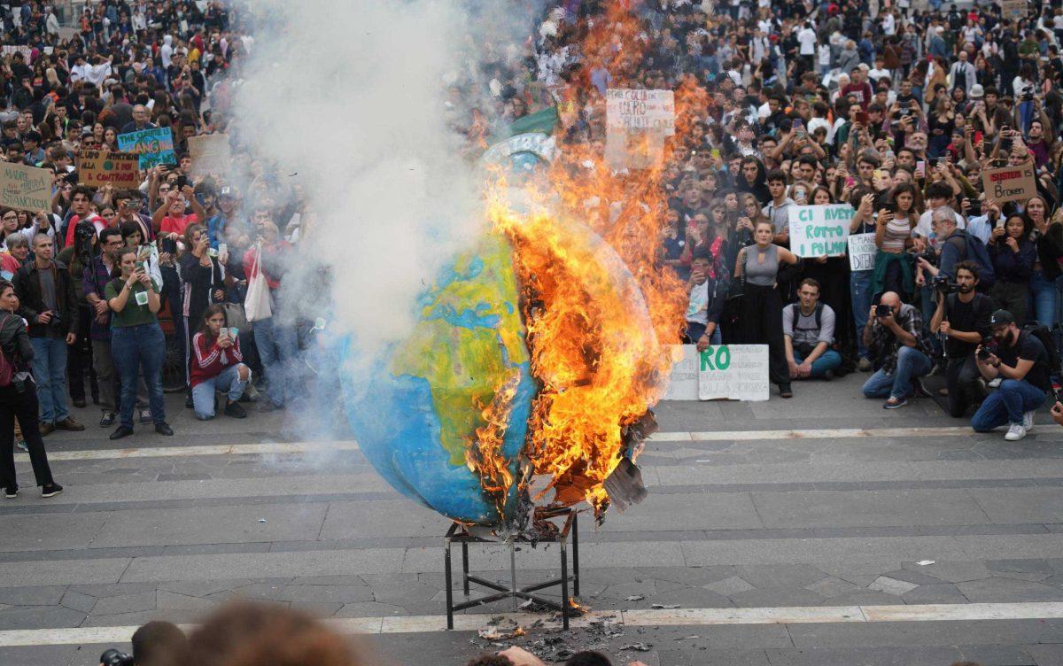 Students set fire to a replica of the planet Earth during a worldwide protest demanding action on climate change, in Milan, northern Italy, Friday, Sept. 27, 2019. The protests are inspired by Thunberg, who spoke to world leaders at a United Nations summit this week. (Nicola Marfisi/ANSA via AP)