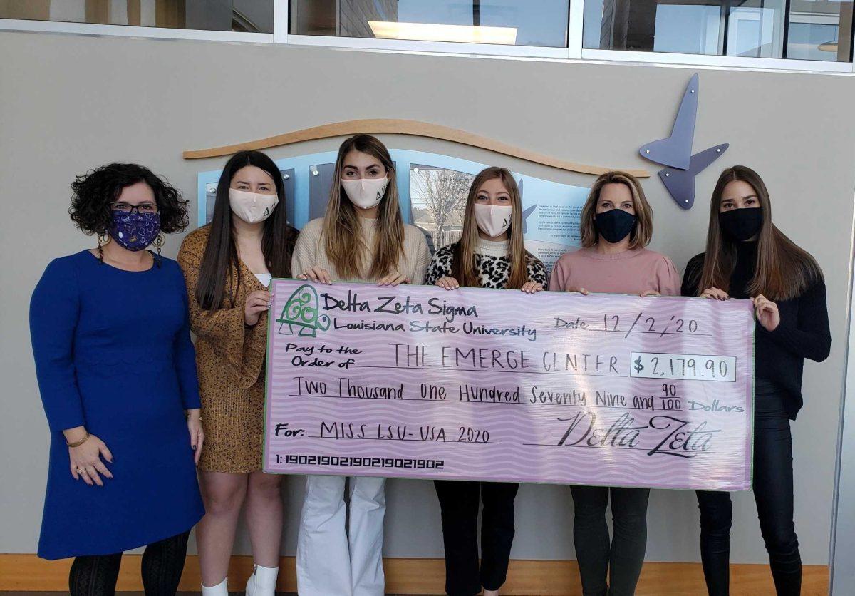 Members of Delta Zeta present a check to The Emerge Center after the sorority raised money for the charity in 2020.