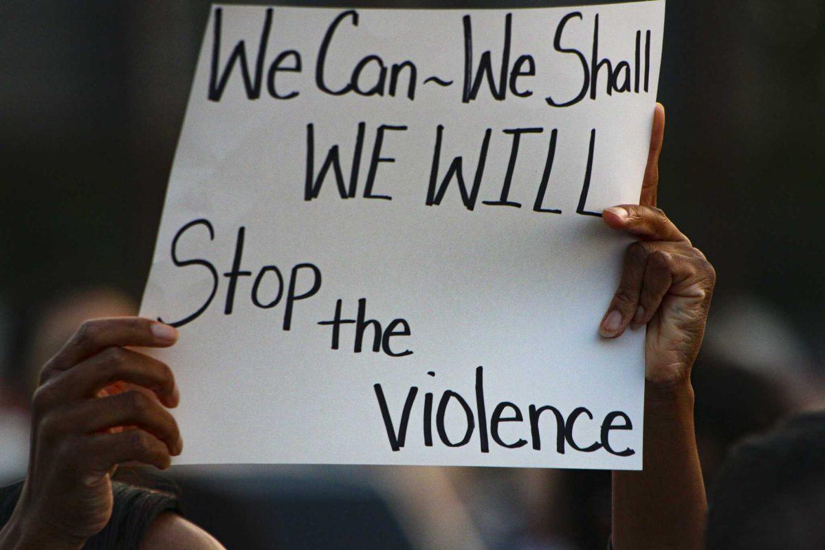 A marcher holds up her sign on Thursday, Oct. 1, 2020 during Cease Fire BR March Against Violence on Plank Road in Baton Rouge, LA.