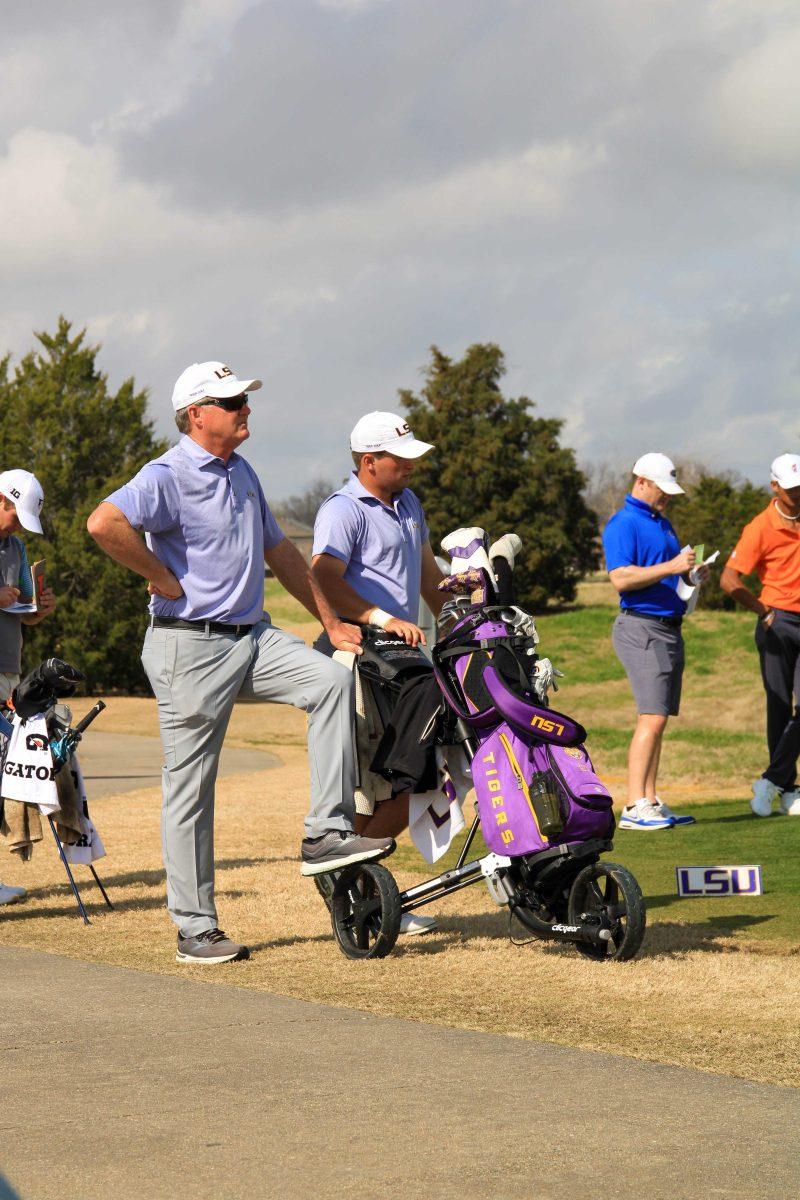 LSU men's golf junior Garrett Barber and head coach Chuck Winstead wait to move to the next hole Friday, Feb. 26, 2021 during the LSU Invitational at the University Club on Memorial Tower Drive in Baton Rouge, La.