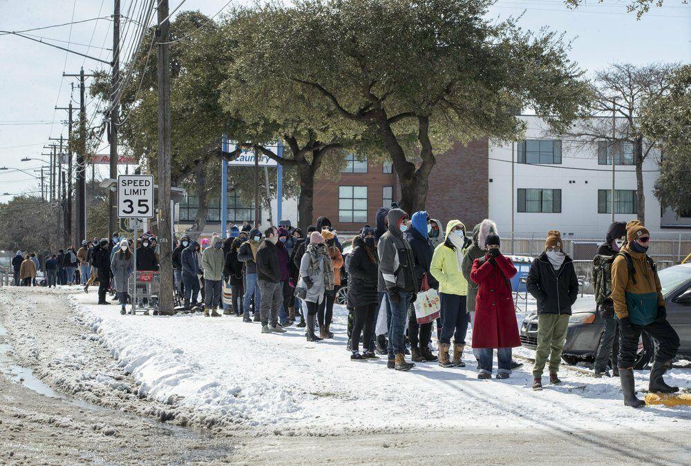 FILE - People wait in a long line to buy groceries at H-E-B on South Congress Avenue during an extreme cold snap and widespread power outage on Tuesday, Feb. 16, 2021, in Austin, Texas. (Jay Janner/Austin American-Statesman via AP)