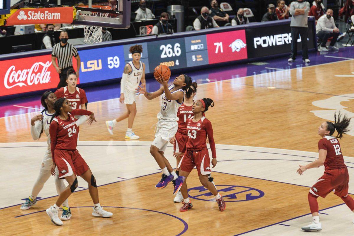 <p>LSU women’s basketball senior guard Khayla Pointer (3) attempts a layup as the clock winds down on Feb. 21, 2021 during LSU’s 64-74 loss against Arkansas in in the Pete Maravich Assembly Center on N Stadium Dr.</p>