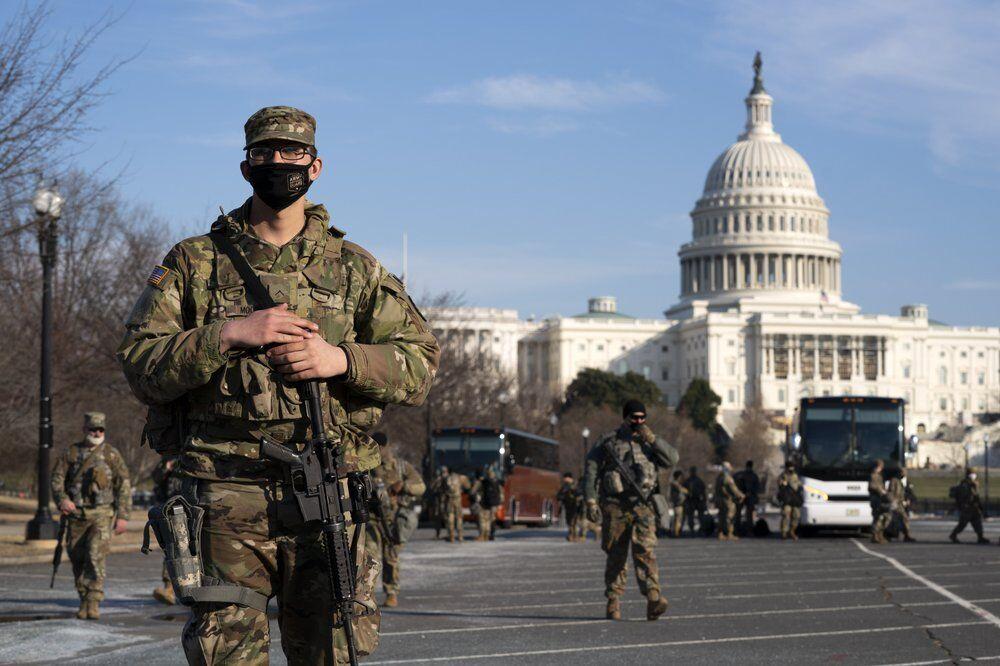 Members of the national guard patrol the area outside of the U.S. Capitol during the impeachment trial of former President Donald Trump at Capitol Hill in Washington, Tuesday, Feb. 9, 2021. (AP Photo/Jose Luis Magana)