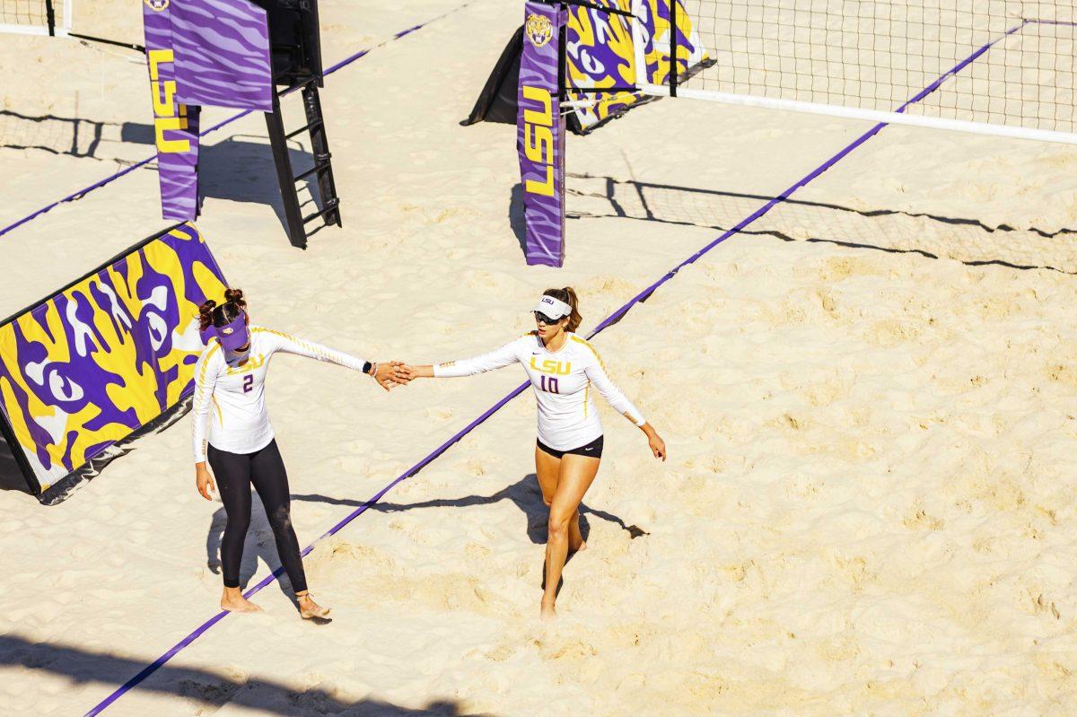 LSU beach volleyball sophomore Allison Coens (2) and junior Hunter Domanski (10) high-five during the Purple vs. Gold scrimmage on Saturday, Feb. 15, 2020 at the Beach Volleyball Complex.