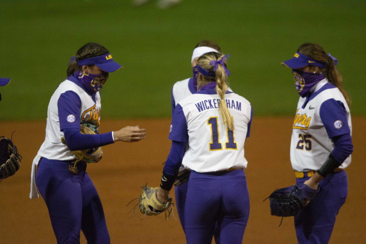 LSU softball&#8217;s infield shakes hands before the inning starts during the Tigers' 8-4 loss against Duke on Friday, Feb. 12, 2021, at Tiger Park.