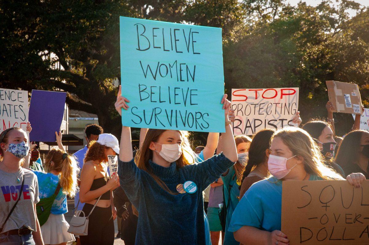 LSU student body vice president Hannah Barrios stands with a protest sign on Friday, Nov. 20 at Pete Maravich Assembly Center on N Stadium Dr.