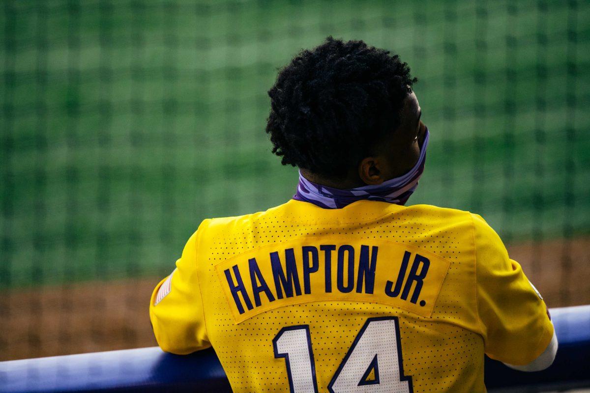 LSU baseball sophomore outfielder Maurice Hampton Jr. (14) rests in the dugout Friday, Jan. 29, 2021 during baseball white vs. gold media day at Alex Box Stadium on Gourrier Avenue in Baton Rouge, La.