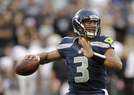 FILE - This Aug. 30, 2012 file photo shows Seattle Seahawks rookie quarterback Russell Wilson dropping back to pass against the Oakland Raiders in the first half of a preseason NFL football game in Seattle. Youth and inexperience have taken over the most important position in the NFL. Ten starting quarterbacks will have one year or less of experience this season, with five teams letting rookies run the show. (AP Photo/Stephen Brashear, File)