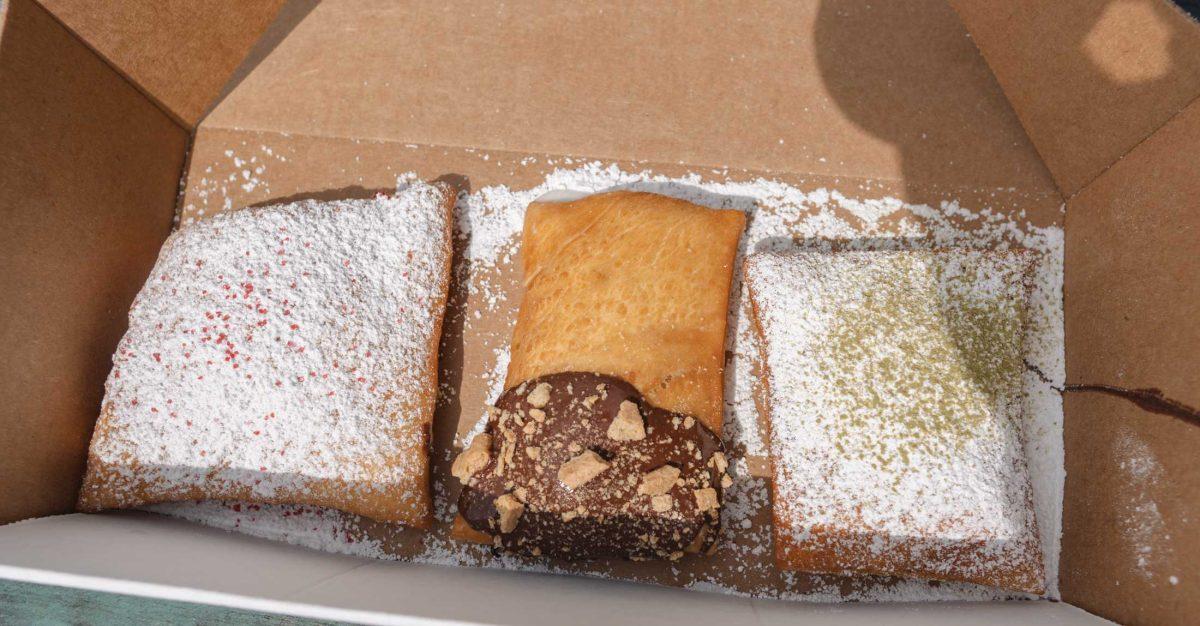 Raspberry (left), S&#8217;mores (center), and Matcha (right) beignets sit in their takeout box on Mar. 11, 2021 in front of the Vintage at 333 Laurel Street.