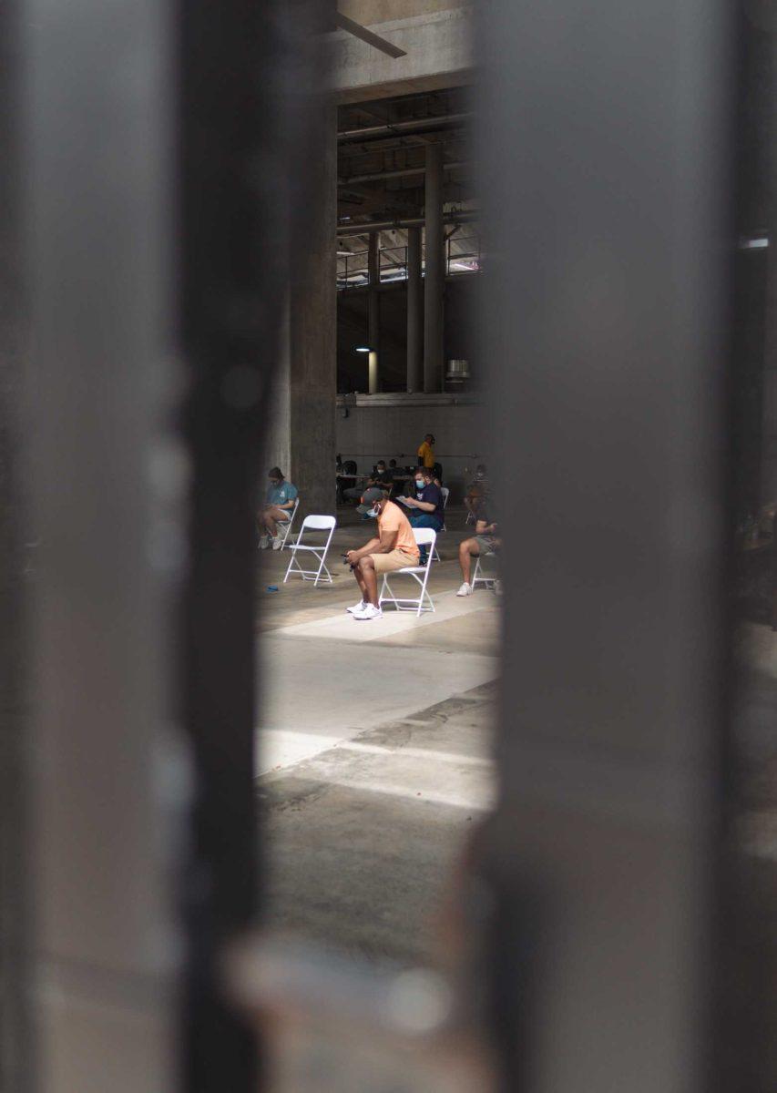 Several people sit in the observation area on Mar. 14, 2021 after receiving their COVID-19 vaccine at Tiger Stadium.