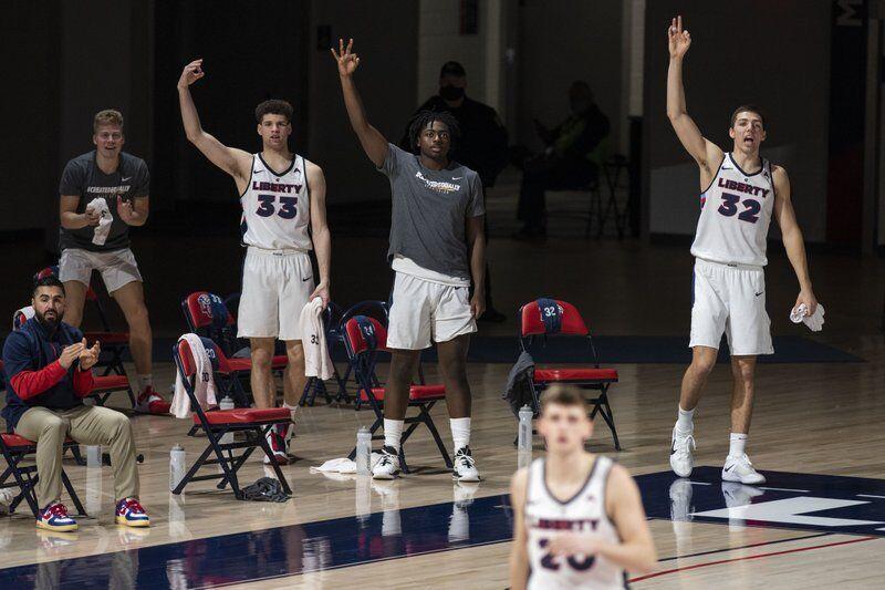 Liberty players celebrate a successful three-point basket by a teammate during an NCAA college basketball game against North Alabama in Lynchburg, Va., Monday, Feb. 22, 2021. (Kendall Warner/The News &amp; Advance via AP)